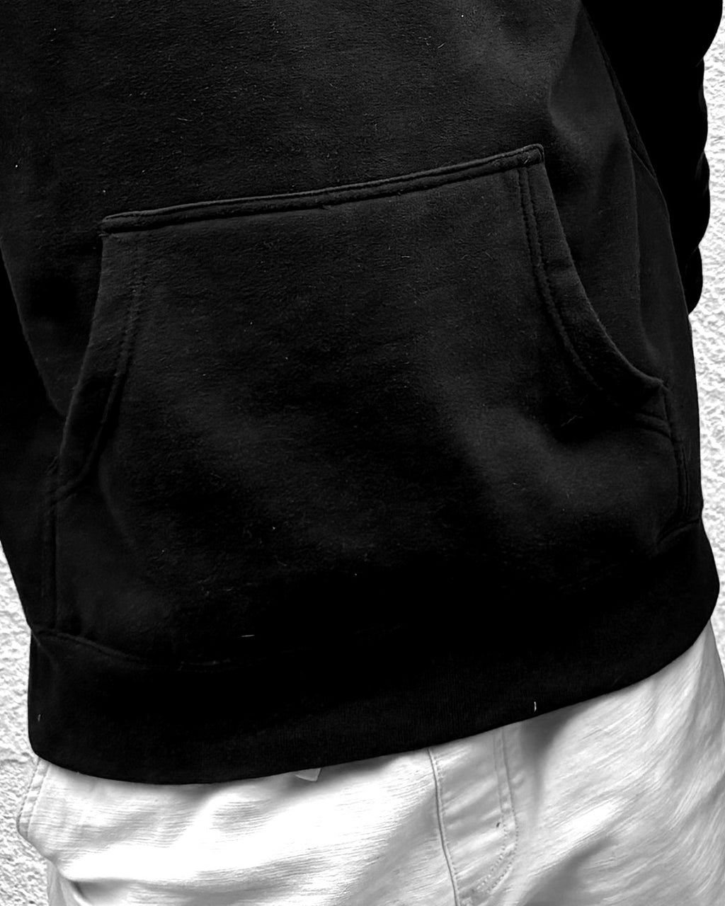 LOW SIGNAL CORE Hoodie in Carbon Black, close-up of kangaroo pocket and 288 gsm fabric