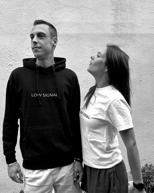 LOW SIGNAL CORE Hoodie in Carbon Black, worn — black and white